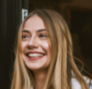 A headshot of a lady smiling